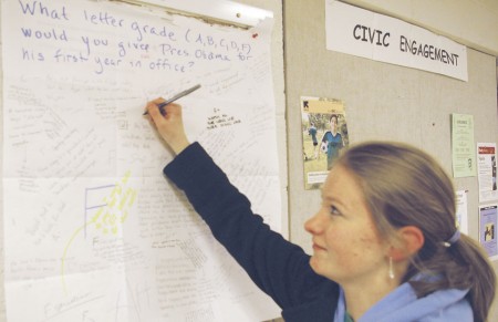 Get Engaged: Molly Gallagher adds her opinion to the Wall Poster Democracy board, which asked students to grade President Obama on his first year in office. There will be a new question every week on the first floor of the Starr building to get students thinking and talking about issues. Photo By: Kristyn Sonnenberg | Photo Editor
