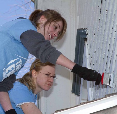 Sprucing Up: Jenna Day and Megan Willenstein, left to right, help give a house a new coat of paint during the BIG Event on April 9. Photo By: Brock Copus | Photographer