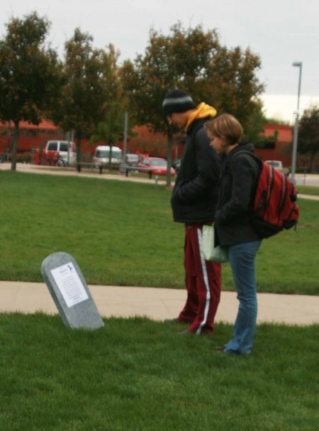 Domestic Abuse Awareness: Ferris students Kendra Sondgrass and Elliot Anderson read stories that are apart of the Tombstone Project that is located in North Quad. Photo By: Kate Dupon | Photo Editor Domestic Abuse Awareness: Ferris students Kendra Sondgrass and Elliot Anderson read stories that are apart of the Tombstone Project that is located in North Quad. Photo By: Kate Dupon | Photo Editor